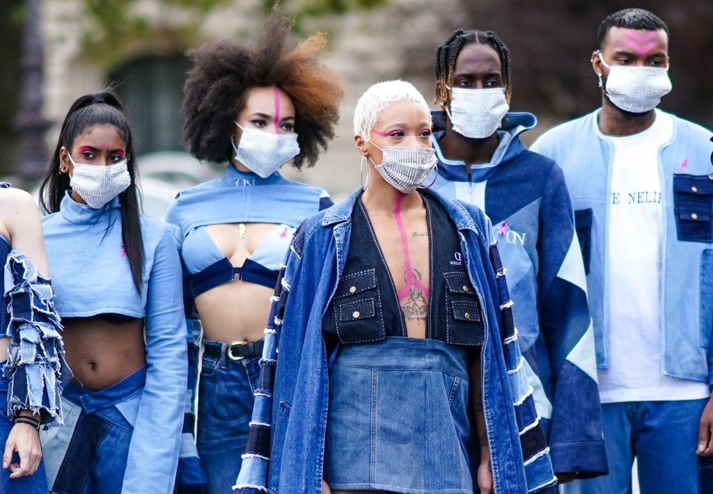 Models wearing blue denim outfits from Oceane Nelien, pose for Octobre Rose (Pink October) to start breast cancer awareness month, on October 06, 2020 in Paris, France. Photo by Edward Berthelot/ Getty Images