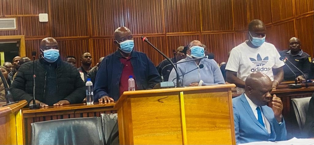 The four accused of a ritual murder appear in court. 