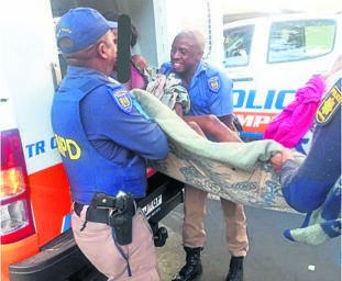 Metro cops help a homeless woman give birth on the corner of Rissik and De Villiers streets in the Joburg CBD. 