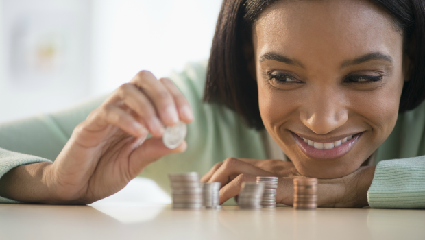 woman stacking coins ( PHOTO:GETTY IMAGES)
