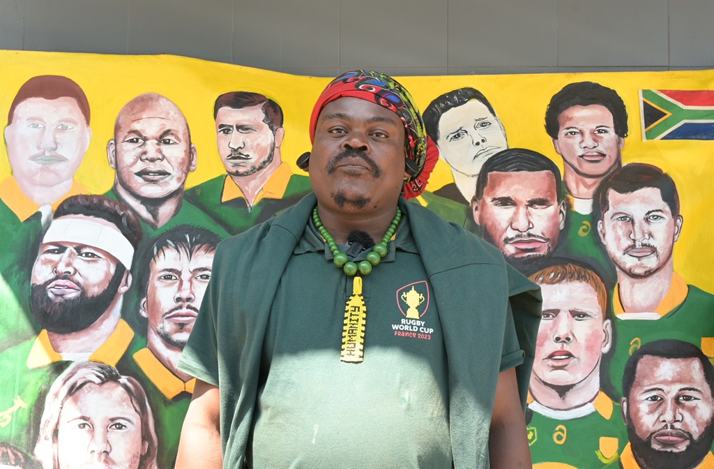 Rasta in front of the painting he did of the Springboks team. Photo by Morapedi Mashashe