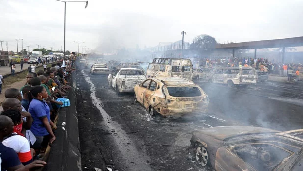 Bystanders and emergency service rescuers look at the scene of an oil tanker explosion on a highway on in Lagos, Nigeria killing nine people in a huge blaze. (File, AFP)