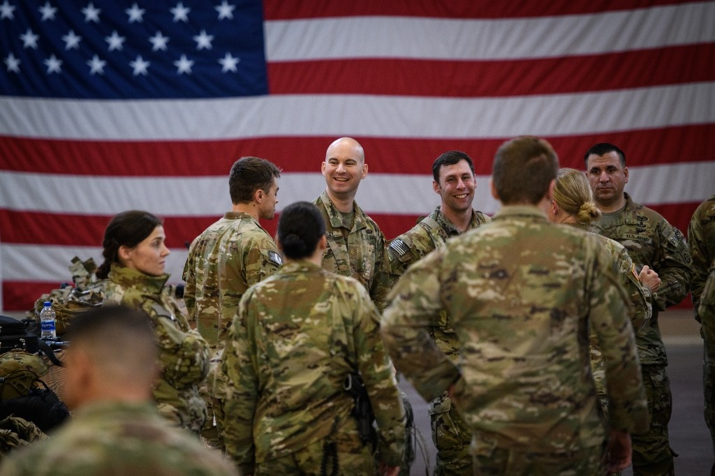 U.S. troops from the Army's 82nd Airborne Division wait at Green Ramp before they head out for a deployment to the Middle East on January 4, 2020 in Fort Bragg, North Carolina. 