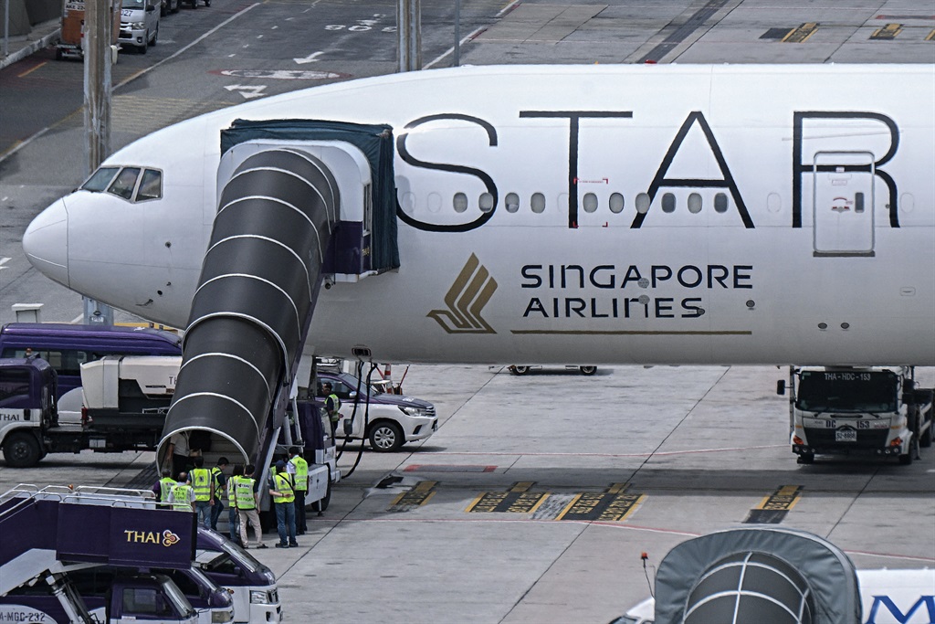 Officials enter the Singapore Airlines Boeing 777-