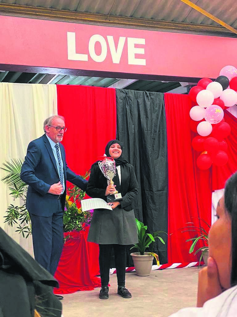 The acting principal of Lotus Highs School Stephen Price presenting the prestigious Principal’s Award to Grade 12 learner, Amar-Rah Kansley at the Matric Valedictory Service.PHOTO:Supplied
