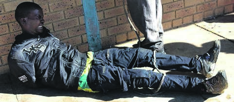A tsotsi in pain after falling from the ceiling at Thopodi Primary School in Etwatwa. Photo by Phineas Khoza