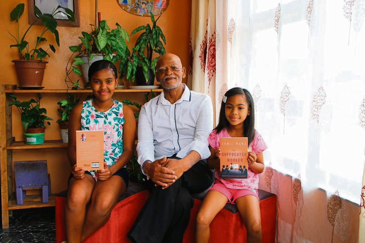 Danie Mars says he is grateful for the support he received from his family, including his granddaughters Shemeeque Davis (left) and Ezekia Davis (right) while he was still writing his first book.               