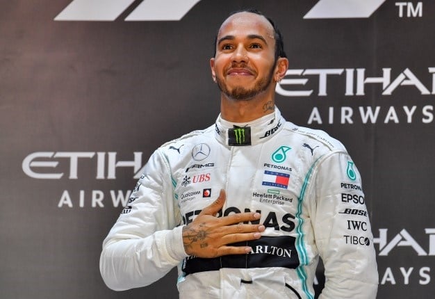 Mercedes' British driver Lewis Hamilton celebrates his victory at the Yas Marina Circuit in Abu Dhabi, after the final race of the Formula One Grand Prix season, on December 1, 2019.  Giuseppe CACACE / AFP