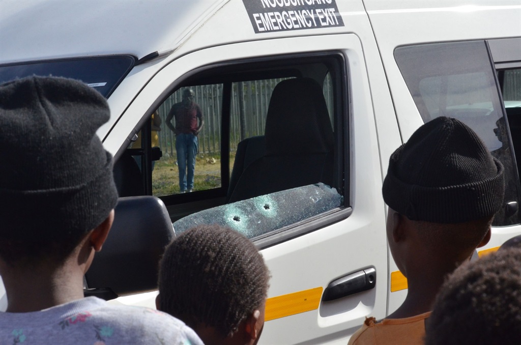 Residents at the scene where the taxi driver was killed. Photo by Lulekwa Mbadamane