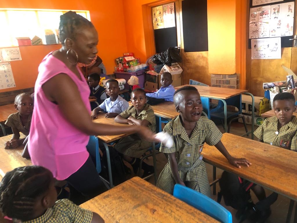 Grade 1 teacher at Bachana Mokwena Primary School in Ga-Rankuwa,  Christina Loate, wiping Gomolemo Mamabolo’s (6) tears as she refuses to sit in class and pleading to go home. Photo: Kgalalelo Tlhoaele