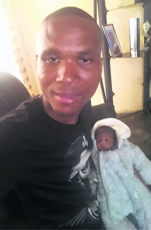 Taximan Nhlonipho with the baby boy he helped deliver inside his taxi. 