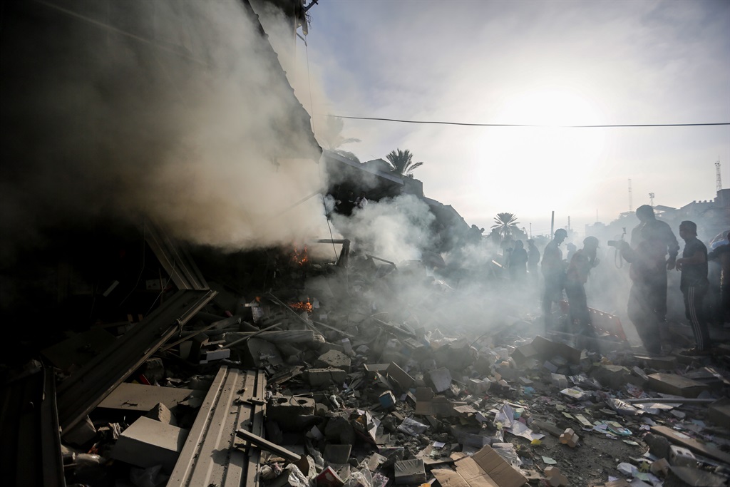 People search through buildings, destroyed during Israeli air raids in the southern Gaza Strip on November 7, 2023 in Khan Yunis, Gaza. Heavy fighting rages in the northern Gaza Strip as Israel encircles the area, despite increasingly pressing calls for a humanitarian truce. The leaders of the main UN agencies issued a rare joint statement to express their indignation. More than 40 per cent of the dead in Gaza after nearly four weeks of war are children. 