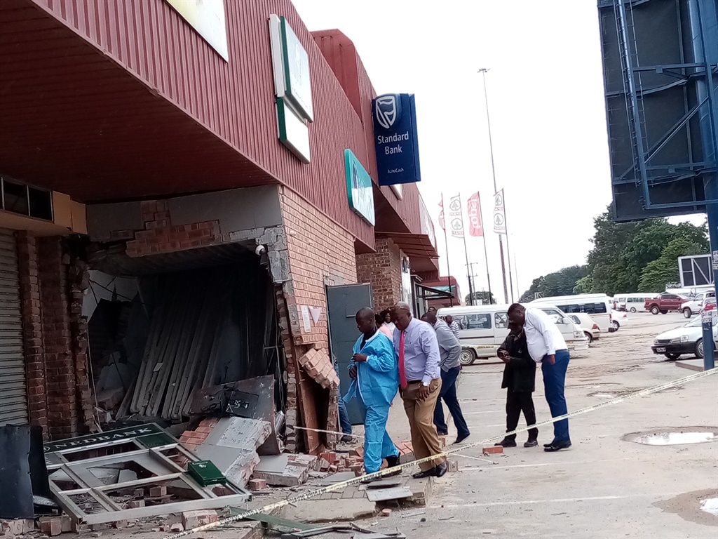 Forensic cops and bomb experts probe the damaged ATM and its strongroom after bombed by criminals at large.

Photos: Oris Mnisi
