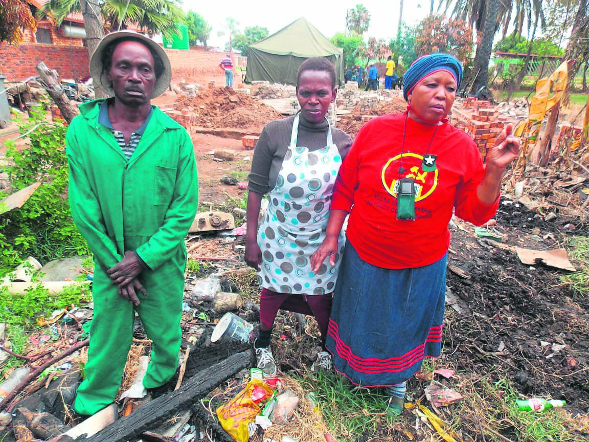 From left: Peter Mojela, Ellen Mareme and Catherine Mareme no longer have a home after a fire ate it.                           Photo by Raymond Morare