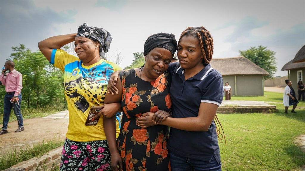 Anto Mpianzi is comforted by family members during a site inspection at the Nyati Bush and River Break lodge near Brits in North West where her son’s body was found. (Chanté Schatz, News24)
