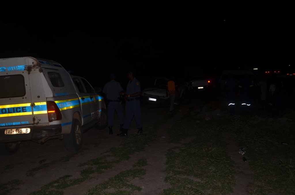 Police inspecting the damaged Isuzu bakkie killed the men. Photo by Oris Mnisi