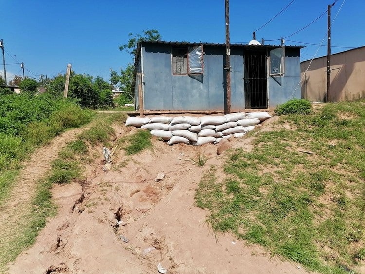 A family of 14 share this one room container. Residents were moved here in 2009 to make way for the FIFA World Cup. 