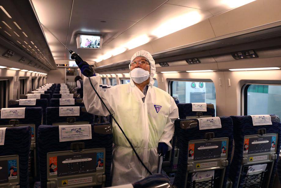 A disinfection worker wearing protective gear sprays antiseptic solution in a train amid rising concerns over the spread of the Wuhan novel coronavirus at a train. Picture: Chung Sung-Jun/ Getty Images