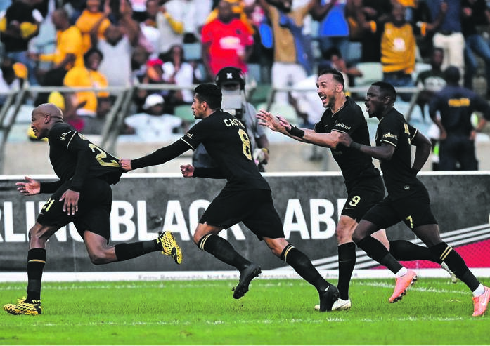Kaizer Chiefs forward Leonardo Castro holds on to Lebogang Manyama as the midfielder celebrates his last-gasp goal during their Absa Premiership game against Golden Arrows at Moses Mabhida Stadium in Durban yesterday Picture: Gerhard Duraan / BackpagePix
