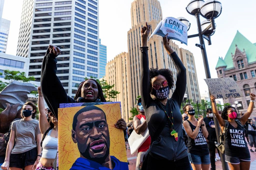 People raise their fists as they march during an event in remembrance of George Floyd in Minneapolis, Minnesota, on 23 May 2021.