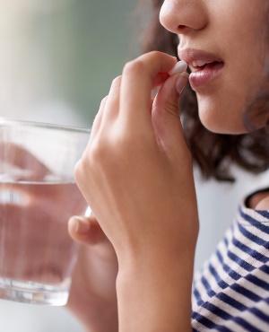 Girl drinking medication. (PHOTO: Getty/Gallo Images