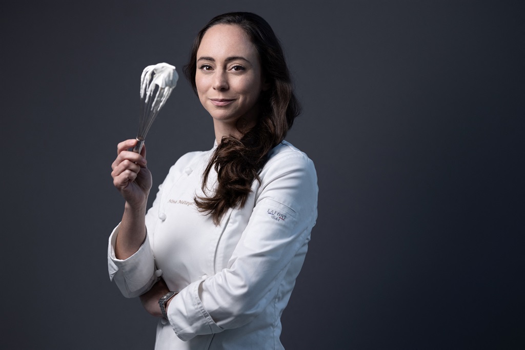A picture taken on November 6, 2023 shows French World pastry champion Nina Metayer posing at her workshop in Issy-Les-Moulineaux, outside Paris.