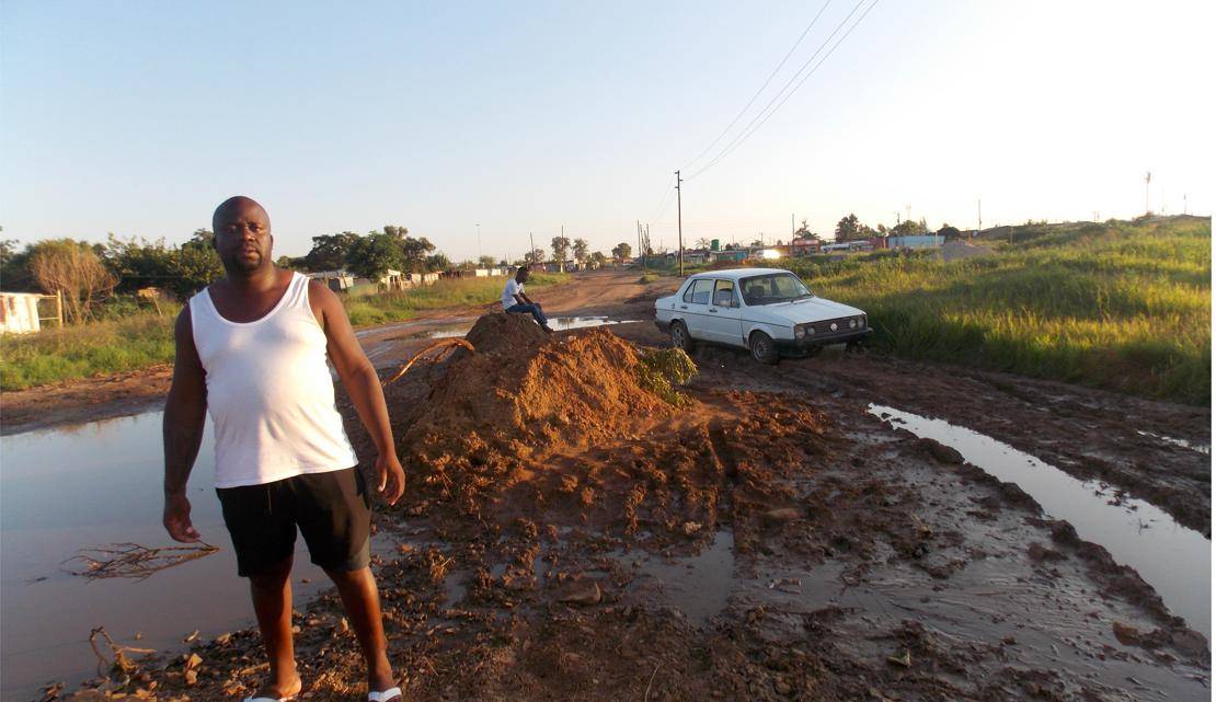 Community leader Lucky Moagi wants this road in Mamelodi East fixed. Photo by Aaron Dube