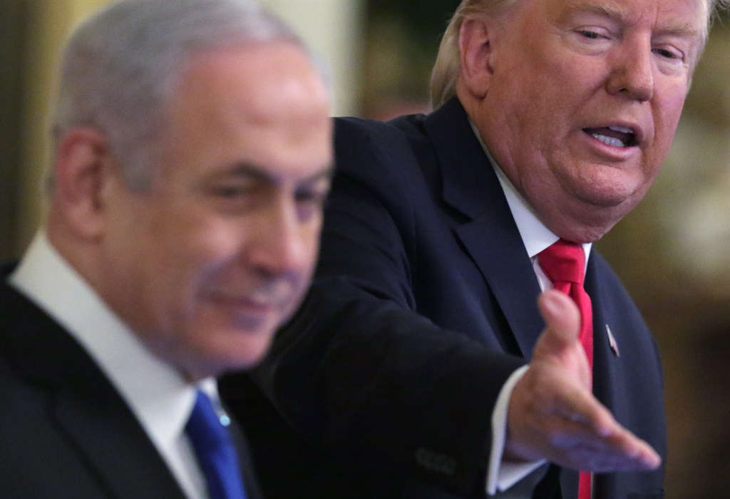 US President Donald Trump gestures during a press conference with Israeli Prime Minister Benjamin Netanyahu (L) in the East Room of the White House in Washington, (AFP)