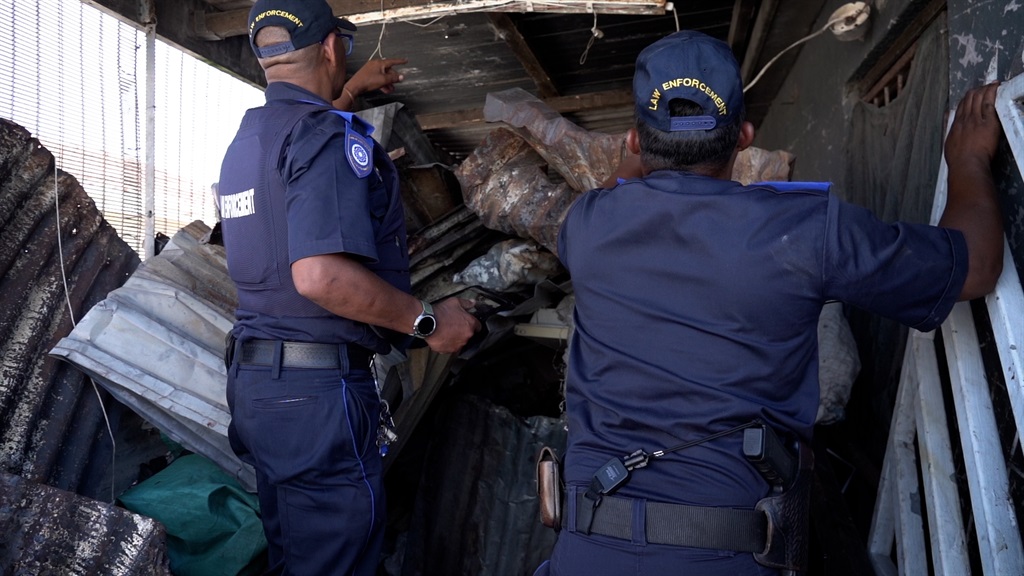 City of Cape Town law enforcement inspect a scrap dealer in Lavender Hill.