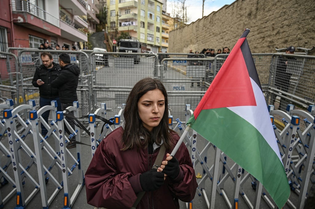 A protester holds a Palestine flag (AFP)