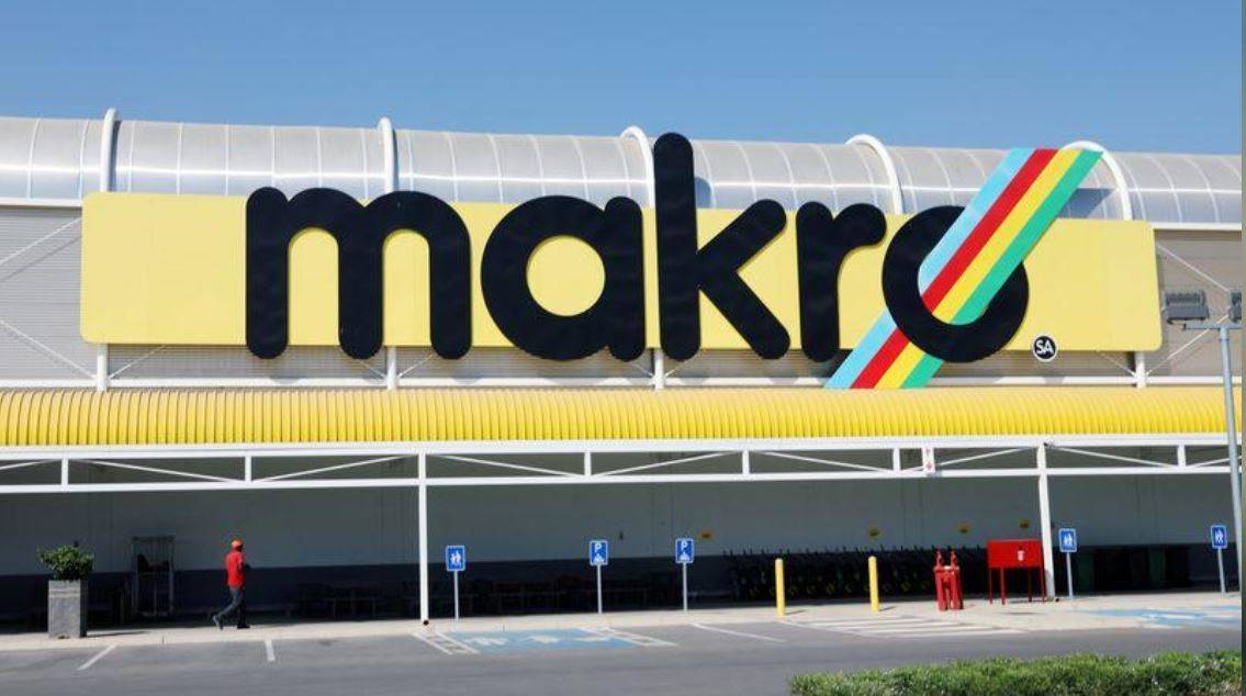 A worker walks beneath a logo at Makro in Riversands, Midrand. Picture: Siphiwe Sibeko / Reuters