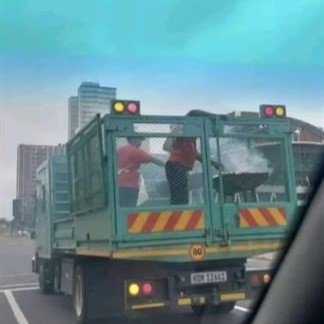 Ethekwini employees braaing meat at the back of a municipal truck.  