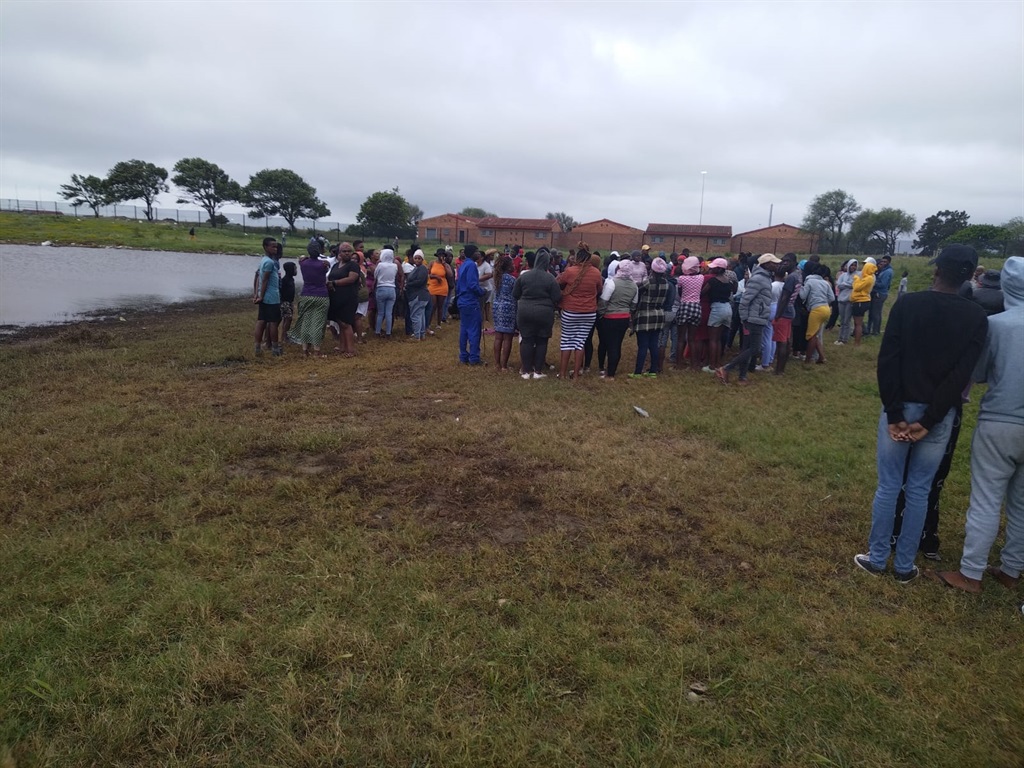 Residents gathered at the pond where a six-year-old boy drowned.
