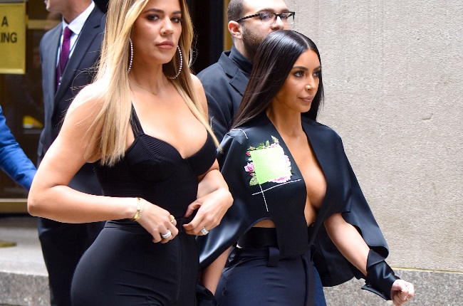 Kim and Khloe Kardashian are two of the celebs who've popularised the current 'trendy' body type deemed most attractive. (Photo by Robert Kamau/GC Images)