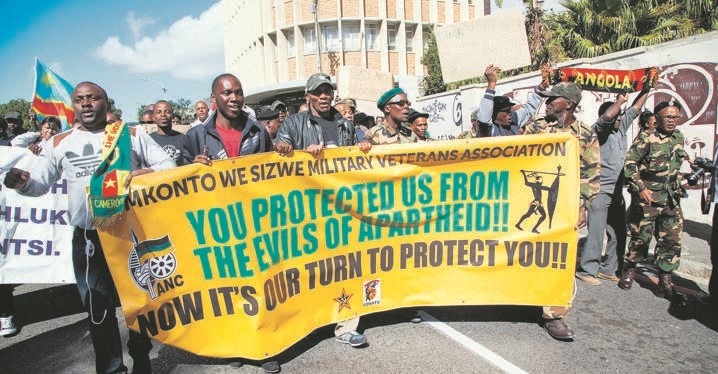 Members if the Umkhonto we Sizwe Veterans Association carry a banner showing their support for undocumented migrants during a march against xenophobia. They are joined by migrants, who also hold banners and display the flags of their home countries. Picture: Ashraf Hendricks / Anadolu Agency / Getty images 