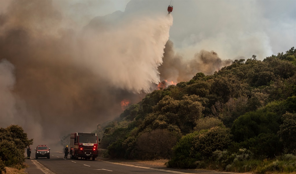 Helicopters drop water on fires near Miller's Point on 20 December 2023 in Simon's Town.