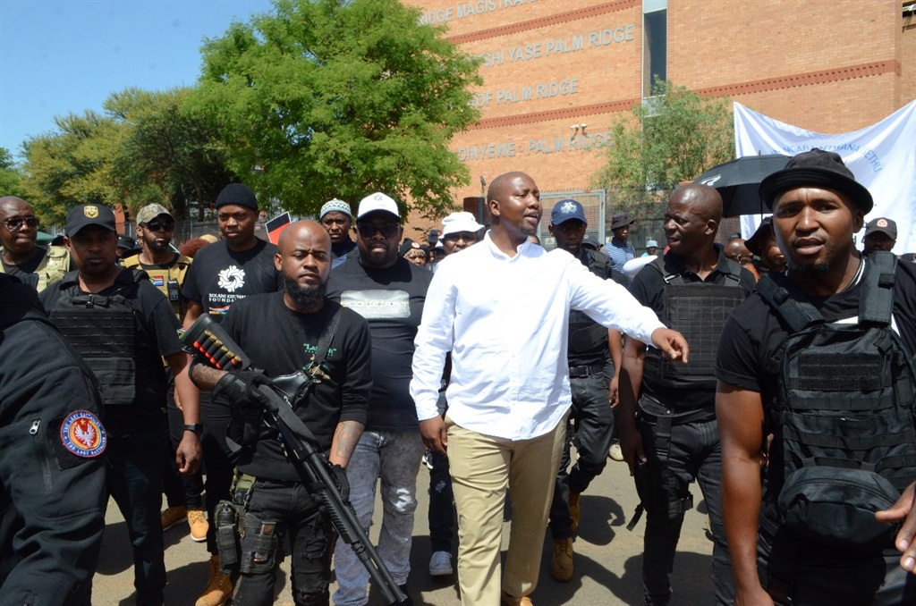 Former Sizok'thola presenter Xolani Khumalo is escorted by armed security after he appeared in the Palm Ridge Magistrates Court in November. Photo by Happy Mnguni