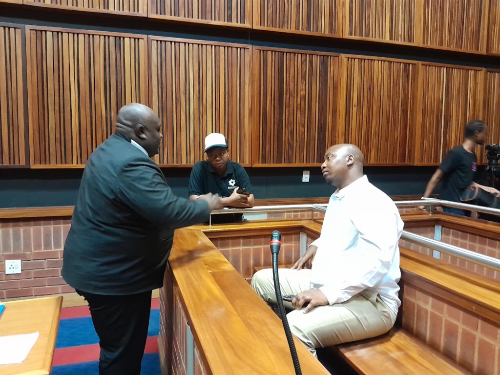 Advocate Prince Mafu talking to his client Xolani Khumalo IN the Palm Ridge Magistrates Court. Photo by Happy Mnguni