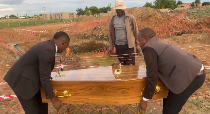 Family members with the coffin of Keamogetswe Ntuli conducting a ritual at the scene where the little boy lost his life. Photo by Keletso Mkhwanazi