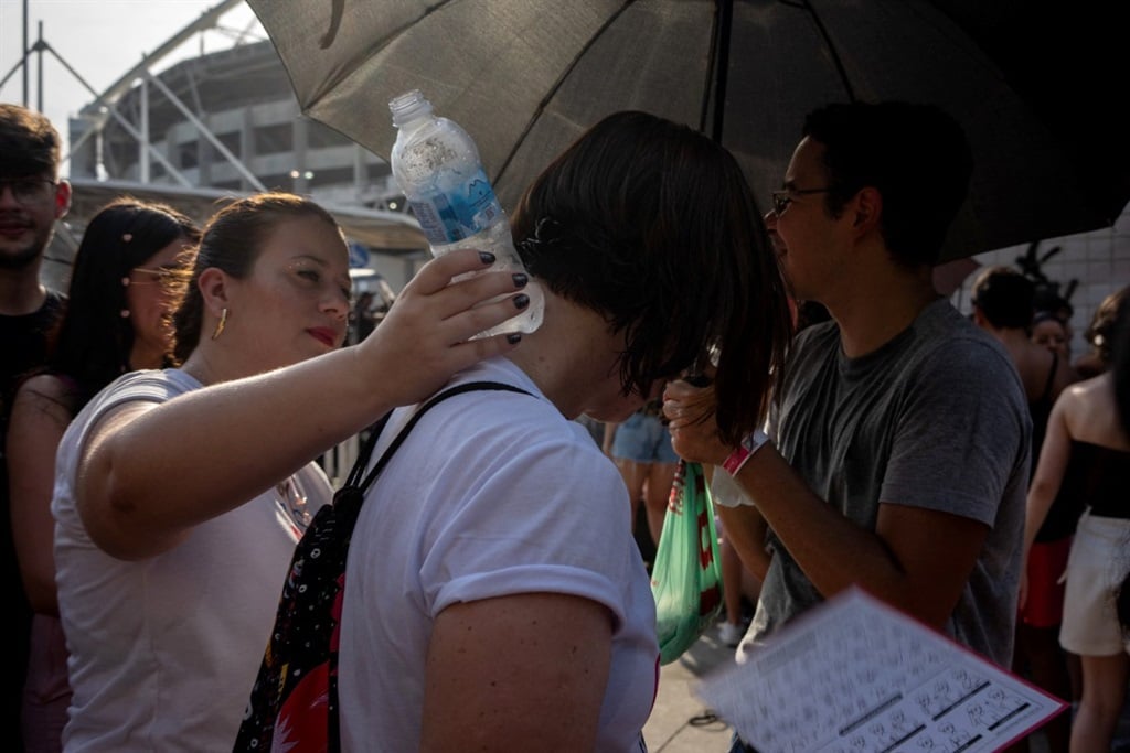 Fans of US singer Taylor Swift queue outside the Nilton Santos Olympic Stadium before Swift's concert, "Taylor Swift: The Eras Tour", amid a heat wave in Rio de Janeiro.