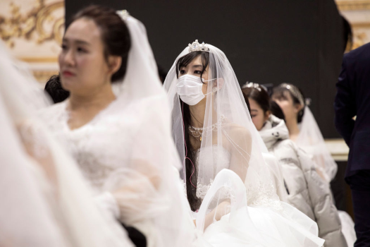 Thousands of couples attend a mass wedding held by
