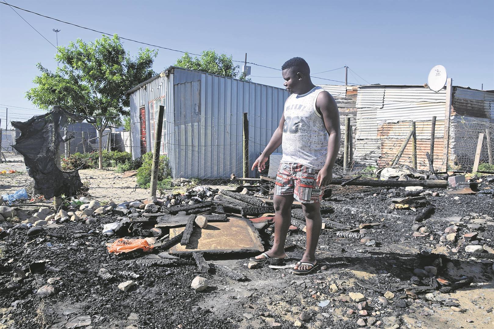 Jabli Mbalaka shows where three people died in a shack fire. Photo: Namhla Monakali 