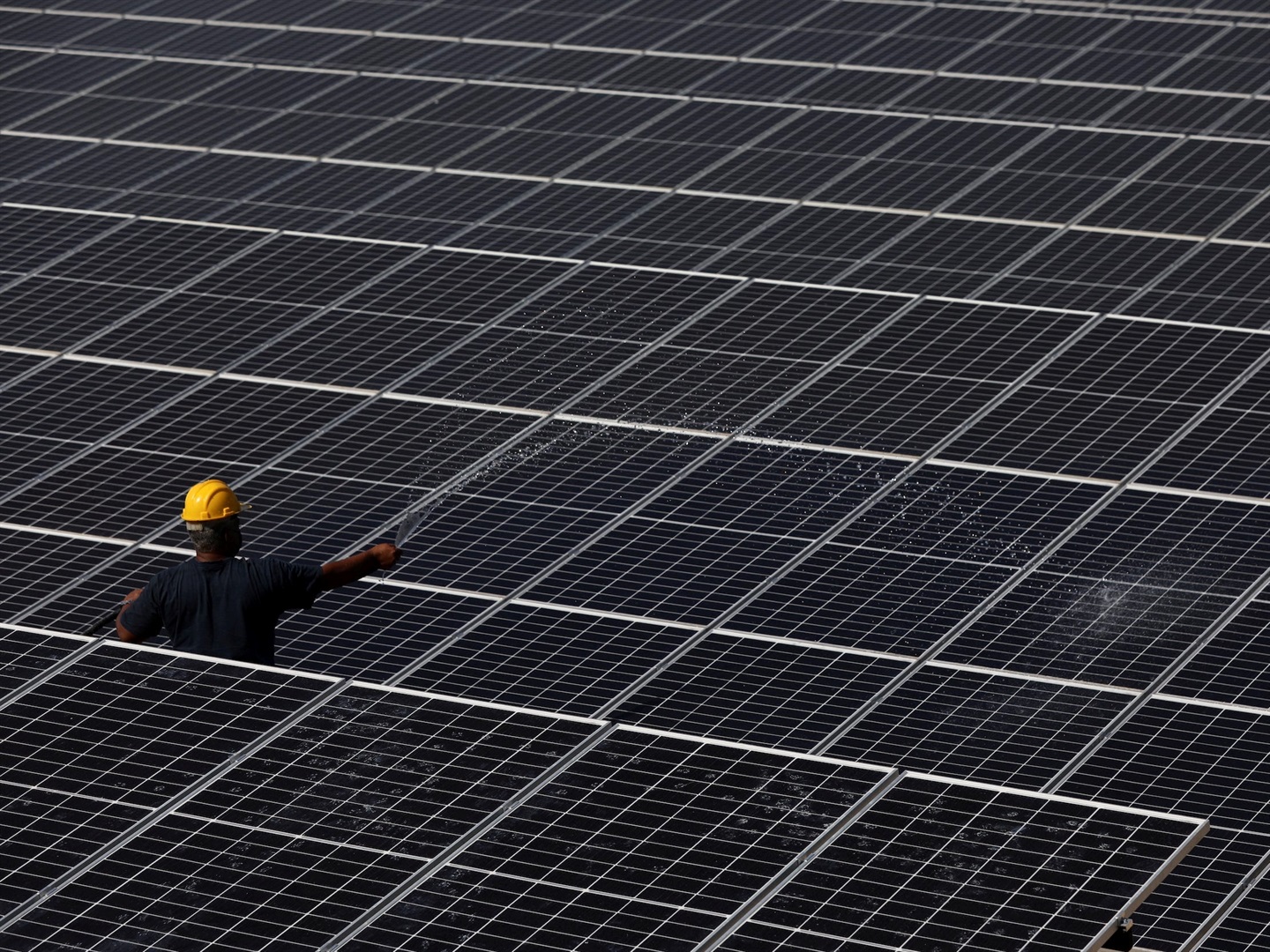 An employee works among solar panels at Bemol Solar plant outside Manaus, Amazonas state, Brazil, on August 23, 2021. Bruno Kelly/Reuters