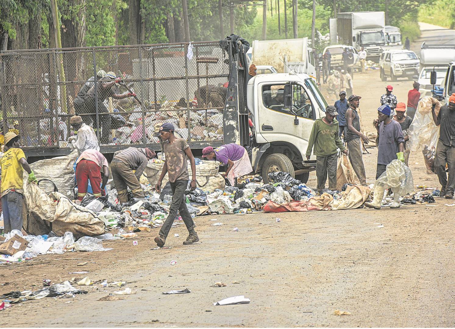 Waste-pickers scour through piles of rubbish dumped outside the New England Road landfill.