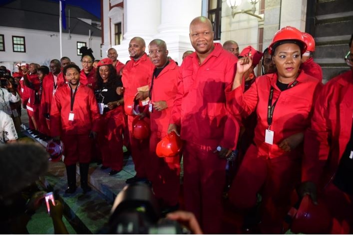 EFF leader Julius Malema and other members outside parliament after the party left the SONA address. Photo by Trevor Kunene