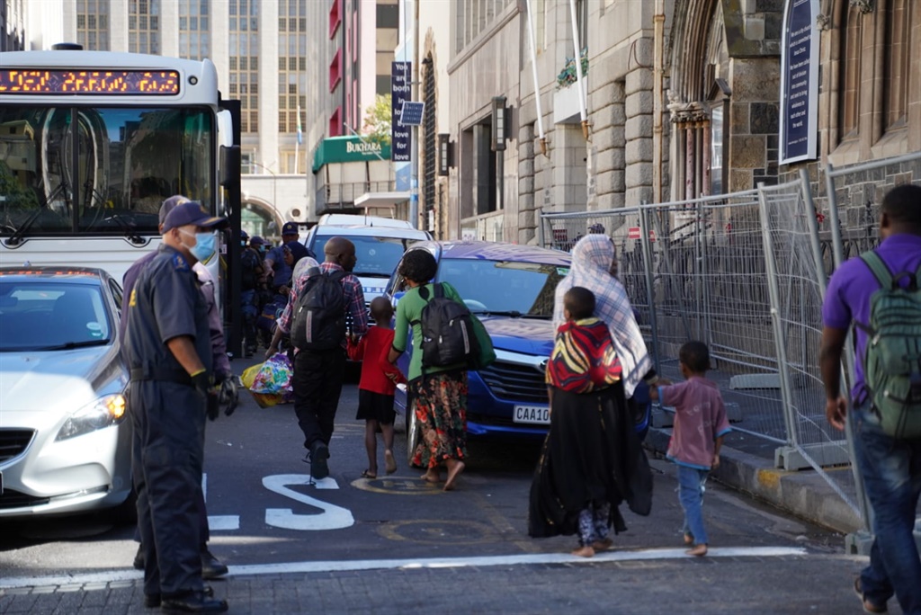 File photo: Police escourt refugees, who were living in the Central Methodist Church in Cape Town, into buses. (Jay Caboz, Business Insider SA)