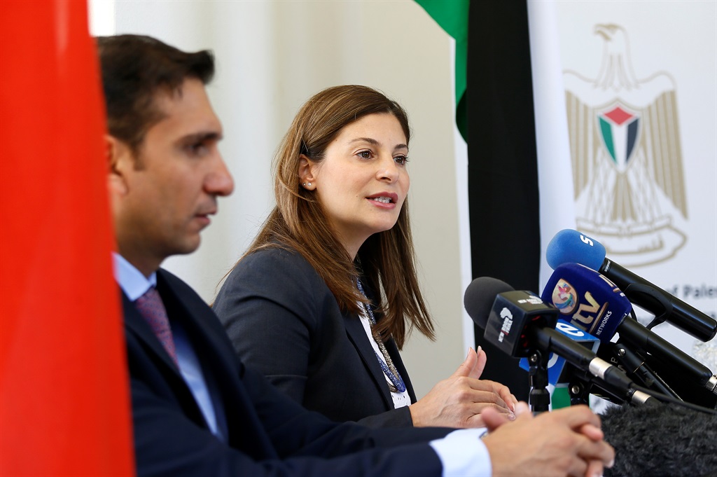 Hassona Aldramy (L) looks on as Palestine Ambassador Hanan Jarrar (R) briefs the media in Pretoria.