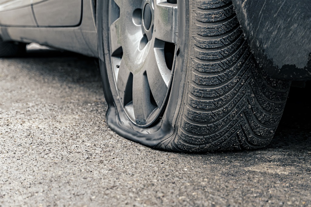 flat car tire close up, punctured wheel8BIM