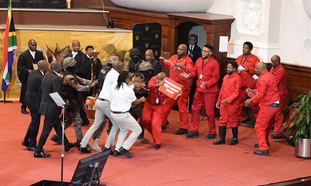 Julius Malema and EFF MPs storming the stage during President Cyril Ramaphosa’s State of the Nation Address in February 2023. Photo by Gallo Images