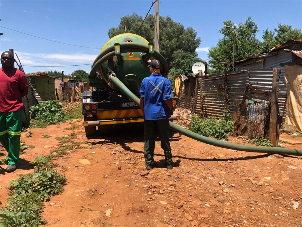 Sewer vacuum trucks operating at Thembelihle informal settlements in Lenasia.